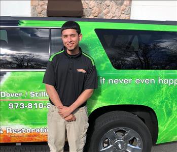 male posing in black servpro shirt in front of a truck