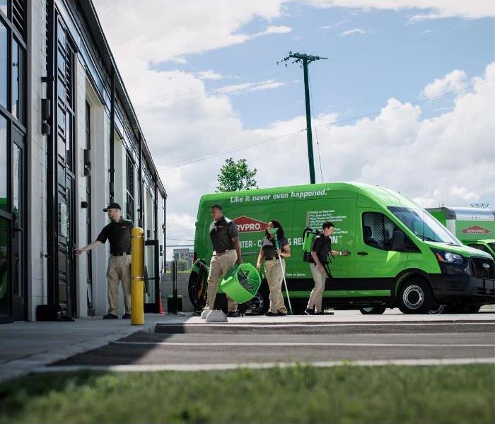 crew unloading a branded SERVPRO vehicle before heading in to a commercial job